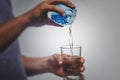 person pouring water in glass over white background Royalty Free Stock Photo