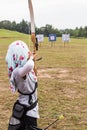 Person practicing at outdoor archery target range Royalty Free Stock Photo