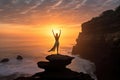 a person practicing yoga on a cliff overlooking the sea at sunrise Royalty Free Stock Photo