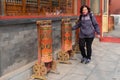 Person in Prayer Spin the prayer wheel at the Lama Temple