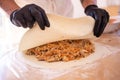 person preparing meat tart on a table