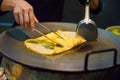 Person Preparing Pineapple Pancake At Market Stall