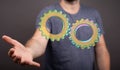 Person presenting a 3D rendering digital gears for business success