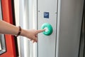 The person presses the stop button in the train. Royalty Free Stock Photo