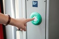 The person presses the stop button in the train. Royalty Free Stock Photo