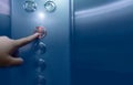 Person pressing on the fifth floor of elevator button. Hand press number 5 on button inside office or hotel lift. Index finger Royalty Free Stock Photo