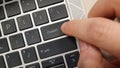 A person pressing a keyboard key with the word ChatGPT