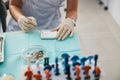 Person producing dental fillings from powder and drop of oil