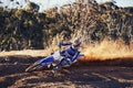 Person, professional motorcyclist and dirt track for competition, extreme sports or outdoor race. Expert rider on Royalty Free Stock Photo