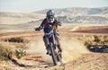 Person, professional motorcyclist and dirt track for race, extreme sports or outdoor competition. Expert rider on Royalty Free Stock Photo