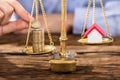 Person Protecting Justice Scale With Coins And House Model Royalty Free Stock Photo