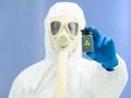 Person in protective suit holding isotope sample