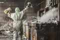 person in a protective suit tossing trash into a large industrial incinerator