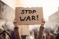 Person in protest crowd holding up cardboard sign with text \'Stop war Royalty Free Stock Photo