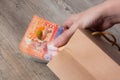 Person pulls the money out of the bag. Tenge, Kazakhstan, banknote. Kraft package with paper currency. National currency of