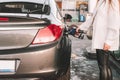 Person pumping gas. Fuel petrol for car at gasoline oil station nozzle in tank. Hand and black refueling gun close-up Royalty Free Stock Photo