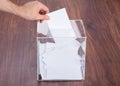 Person putting ballot in box