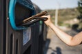 Person putting a card in the blue recycling bin, material recycling