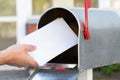 Person Putting Letters In Mailbox Royalty Free Stock Photo