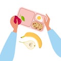 Person putting snacks in lunchbox. Lanchbox with coookies, egg. Human hand holding apple. Banana and pear on table Royalty Free Stock Photo