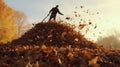 person raking leaves into a large pile for jumping