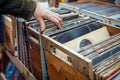 Person Reaching for Record in Wooden Box