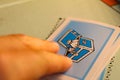 Person reaching towards blue Monopoly Community Chest Card