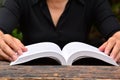 Person read the book on wooden table Royalty Free Stock Photo