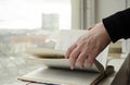 A person reading books near the window. Hands turns over book page Royalty Free Stock Photo