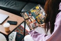 Person reading comic book at home in living room