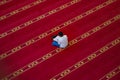 a person reading the qur'an inside a mosque in Lombok, Indonesia