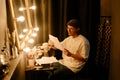 Person Reading Script Beside Illuminated Vanity Mirror