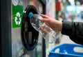 person is recycling plastic bottle at reverse vending machine, promoting environmental sustainability and eco-friendly practices Royalty Free Stock Photo