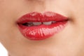 Person, red lipstick and closeup of mouth with makeup for cosmetics, gloss or glow in treatment. Colorful lips of woman