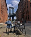 Person Relaxing at Dumbo with Manhattan Bridge view in Brooklyn New York City