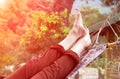 Person relaxing lying in Hammock at rural cottage garden Royalty Free Stock Photo