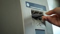 Person removing credit card from ATM, confirming completion of banking operation Royalty Free Stock Photo