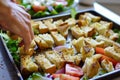 person repurposing stale bread into croutons for a salad