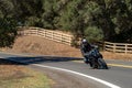 Person riding a motorcycle down a winding road.