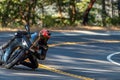 Person riding a motorcycle down a winding road.
