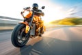 a person riding a motorcycle on a road with blurry trees in the background on a sunny day with a blue sky and white clouds