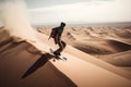 person, riding sandboard down the dunes of the hot desert Royalty Free Stock Photo