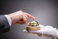 Person Ringing Service Bell Held By Waiter