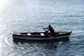 Person rowing a boat at sea
