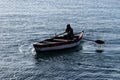 Person rowing a boat at sea