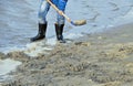 Person in rubber boots on beach