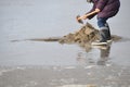 Person in rubber boots on beach