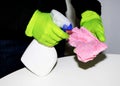 A man wearing cleaning gloves wipes the dining table. Royalty Free Stock Photo