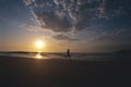 Person running along beach at sunset Royalty Free Stock Photo