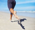 Person, running and feet at beach with exercise, sport and training for marathon by the sea. Workout, fitness and back Royalty Free Stock Photo